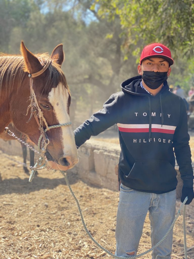 Young man with horse in Guadalajara, Mexico.