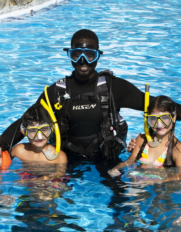 Children scuba diving with instructor in the Caribbean