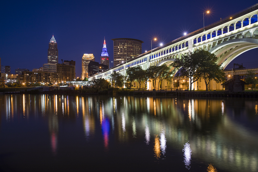 Nighttime scene of the Cleveland skyline and bridges.