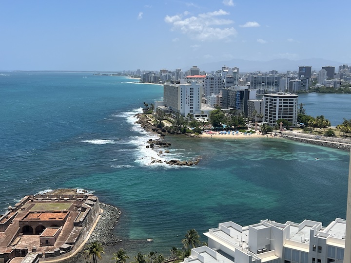 View of Condado neighborhood beachfront and skyline in San Juan, Puerto Rico during the day.